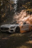 Luxury Cars - A luxury white Mercedes Benz parked in a misty f #10215508