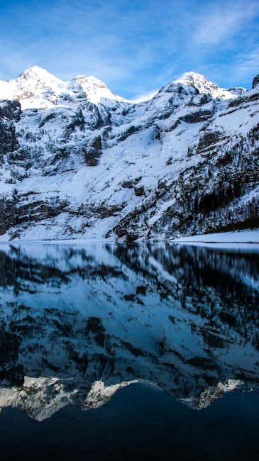 Mountain Landscapes - Snowy mountains reflected in a calm alpine lake #10433049