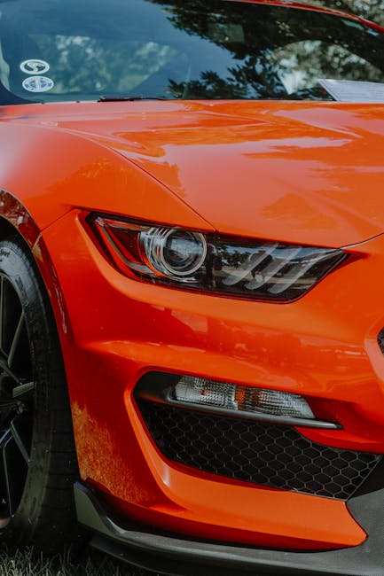 Luxury Cars - Dynamic close-up shot of a shiny orange sports c #12522971