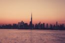 City Architecture - Scenic view of Dubai skyline at sunset featuring #15533154