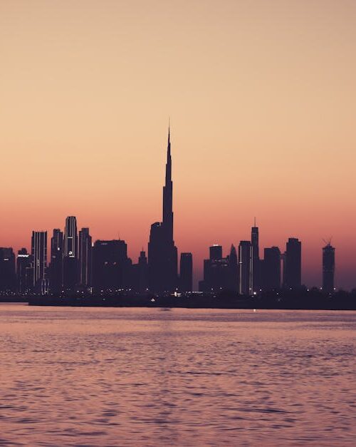City Architecture - Scenic view of Dubai skyline at sunset featuring #15533154