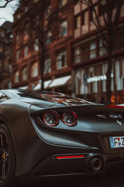 Luxury Cars - Sleek black sports car parked in a vibrant urban #20296990