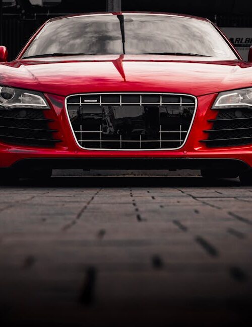 Luxury Cars - Front view of a sleek red sports car parked outd #28554694