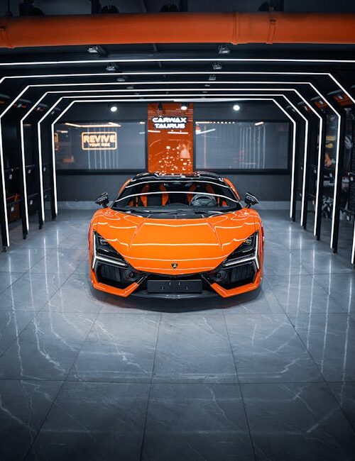 Luxury Cars - Stunning orange sports car displayed in a modern #34054728
