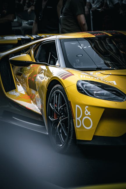 Luxury Cars - Sleek yellow sports car parked at a nighttime ra #34214698