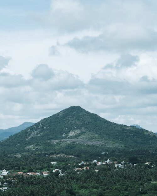 Mountain Landscapes - Lush green hills under a cloudy sky in Bengaluru #34271583