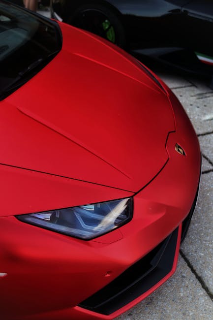 Luxury Cars - Detailed view of a luxury red sports car's front #9290868